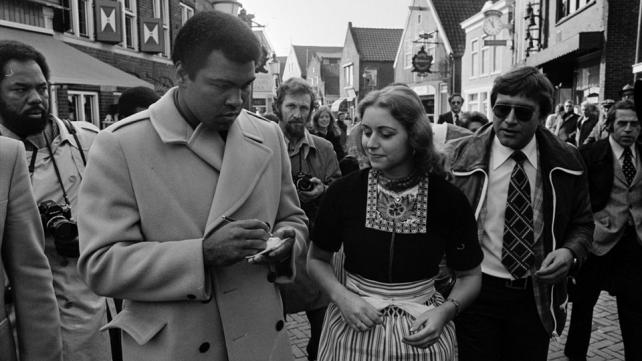 Muhammad Ali signing his autograph