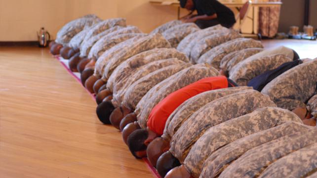 Muslim Soldiers bow down in prayer during the celebration of Eid-Al-Fitr