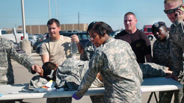 First responders use a table as a stretcher to transport a wounded US Soldier to an awaiting ambulance at Fort Hood, Texas, Nov. 5.