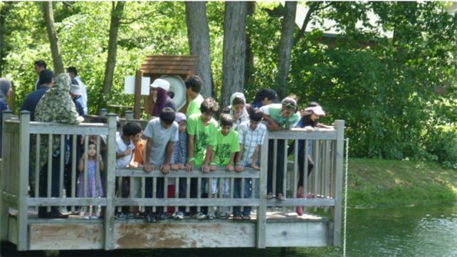 kids at a lake watching