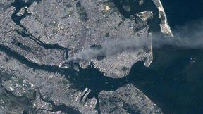 An areal view of the World Trade Center on September 11th 2001.  <a href =  “http://commons.wikimedia.org/wiki/Category:World_Trade_Center_on_9/11#mediaviewer/File:Manhattan_smoke_plume_on_September_11,_2001_from_International_Space_Station_(ISS003-E-5388).jpg”>Link to original photo</a>