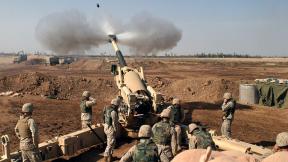 An M-198 155mm Howitzer of the US Marines firing at Fallujah, Iraq, during the Second Battle of Fallujah.