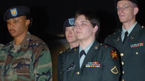 PFC Lynndie England, is escorted by guards and her defense counsels after she was sentenced to three years for prisoner abuse at Abu Ghraib.