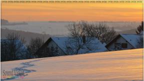 outside winter scene at with snow and sunseting